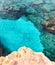 Rocky seabed with clear blue water. Lagre stones in the water, vertical top view. Mediterranean Sea coast.
