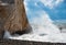 Rocky seashore with wavy ocean and waves crashing on the rocks