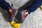 Rocky shoe on a big hook stands with the tip of the sock close up, on the climbing wall in the room