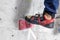 Rocky shoe on a big hook stands with the tip of the sock close up, on the climbing wall in the room