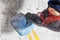 Rocky shoe on a big hook stands with the tip of the sock close up, on the climbing wall in the room