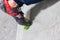 Rocky shoe on a tiny, scanty snare stands with the tip of the sock in close-up on the climbing wall in the room