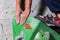 Rocky shoe on a tiny, scanty snare stands with the tip of the sock in close-up on the climbing wall in the room