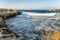 The rocky shore of the beautiful blue sea on a sunny day. Great scenery