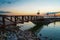 Rocky shore with a bridge against the sky at sunset. Dallas, Texas.