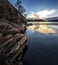 Rocky shore of the lake and the evening sky