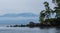 Rocky shore line and snow capped mountains