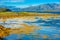 Rocky shore of mountain lake in autumn morning