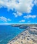 Rocky shore in Porto Torres under huge clouds