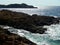 Rocky shore on the sea in great light with a lonely angler