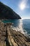 Rocky shore by the sea near touristic town, Riomaggiore, Italy. Background