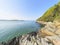 The rocky shoreline of the River Dwyryd on a bright spring day