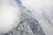 Rocky slope of a mountain partly covered by mist in the Tennen range in the Austrian Alps near the town of Werfen