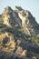 Rocky slope of a mountain with trees. Summit of a mountain in Corsica in France.