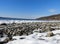 Rocky snow covered shoreline with frozen waves in FLX