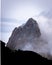 Rocky snowy mountain behind and white clouds. Fitz Roy in Argentina