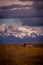 Rocky snowy mountain peaks with the sun rising behind and red clouds. Fitz Roy in Argentina