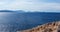 Rocky steep cliff panorama, blue Ionian seascape