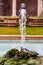 Rocky stone fountain design with clear blue transparent water reflecting the sky and squirt of water flows up under pressure from