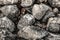 Rocky stone gray hard uneven dark close up shabby granite pattern base