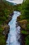 Rocky summer landscape of green forest and powerful streams Slettafossen waterfall. Norway