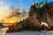 Rocky tropical coastline at sunset