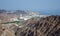 A rocky view over an Omani town near Muscat looking towards the sea.