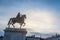 Roi Louis XIV statue on display on the Place Bellecour Square, in downtown Lyon, France, with Basilique Notre Dame de Fourviere