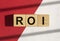 ROI word. Return of investment term. Acronym on cubes