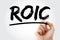 ROIC - Return on Invested Capital acronym with marker, business concept background