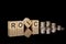 ROIC - text on wooden cubes on dark backround with coins. business concept