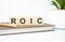 roic word written on wooden cubes with copy space
