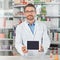 The role of information technology in pharmacy practice is dynamic. a pharmacist holding up a digital tablet. All