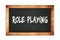 ROLE  PLAYING text written on wooden frame school blackboard