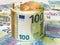 Roll of 100 and 50 euro paper banknotes over money background. Concepts of cash savings and wealth, counting money, accounting of