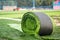 Roll of artificial grass on new soccer field