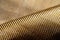 Roll of bulletproof material aramid. Shining aramid kevlar background. Bronze kevlar texture and pattern