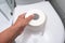 A roll of oilet paper on a toilet cover, concept for constipation and bowel movement