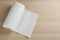 Roll of paper tissues on wooden table, top view. Space for text