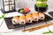 Roll Philadelphia made of Fresh Salmon, Cream Cheese, tuna, avocado and cucumber inside. Salmon sushi roll.