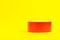 A roll of red duct tape isolated on a yellow background