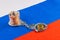 roll of russian paper rubles currency and bitcoin shiner chained with handcuffs on russian flag background