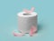 A roll of soft toilet paper on a blue background and delicate pink feathers