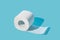 Roll of soft white toilet paper on a blue background.