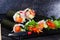 Roll sushi black background different tastes, crab, carrots, lettuce, tofu, salmon, still life, home, stylish, wooden