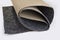 Roll of thin carpet on a white background. Grey polyester texture