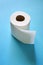 Roll of toilet paper on the blue background. Tissue for use in the toilet room, used for cleaning the dirt in the bathroom.