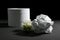 Roll of toilet paper and flowers on dark background