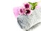 Roll of towel and chrysanthemums pink flowers on white background