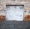 Roll up garage door on brick wall